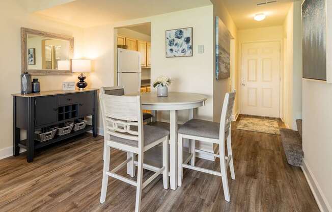 A dining room with a table and chairs.
