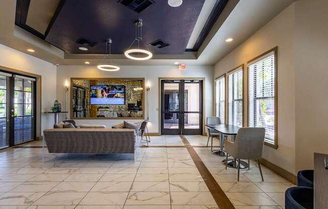 A living room with a grey couch and a television.