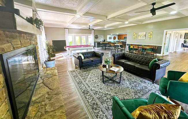 Interior of the clubhouse at Woodbridge Apartments in Bloomington, featuring furniture, pool table, and seating areas.