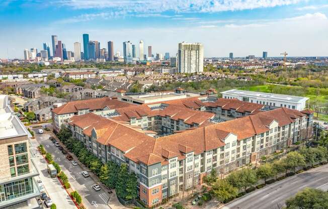 an aerial view of a building with a city in the background