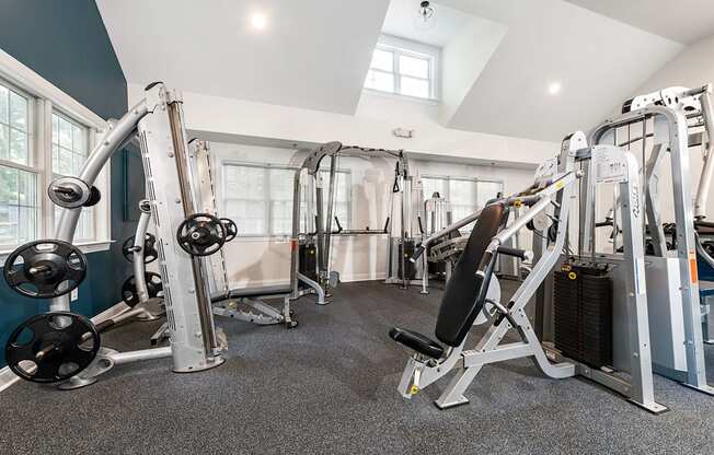 A gym with a variety of equipment including a leg press machine.