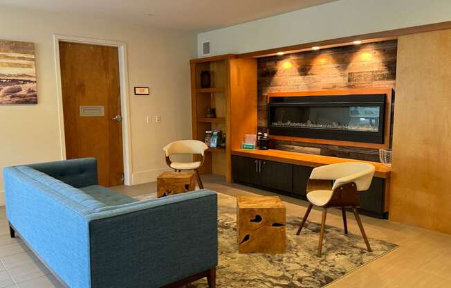 a living room with a couch and chairs and a television at Spyglass Hill Apartments, Bremerton