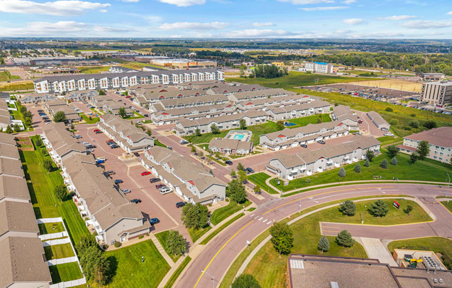 A residential area with houses and a parking lot.