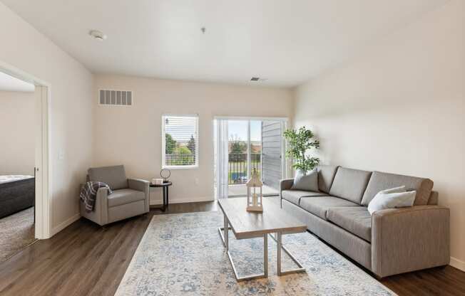 a living room with a couch and a chair and a coffee table