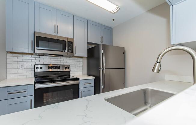 a kitchen with a sink and a microwave