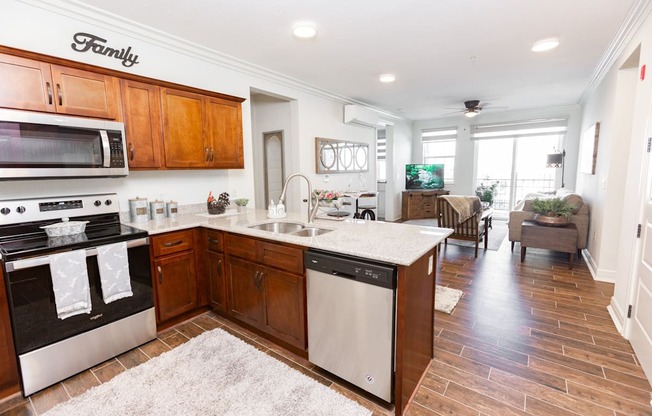 A kitchen with wooden cabinets and a white countertop.at Carson Street Towers, Overland Park Kansas