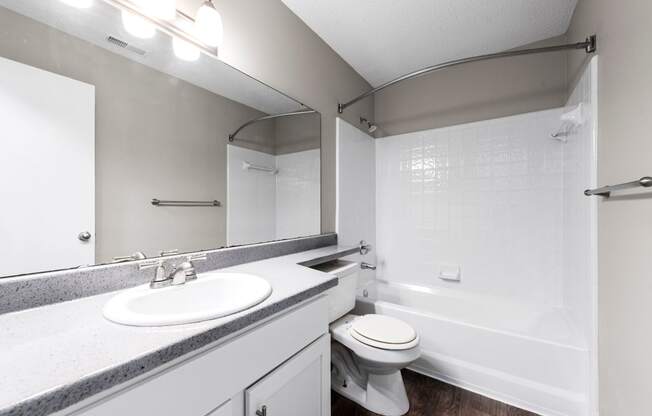 a bathroom with a sink toilet and a bath tub