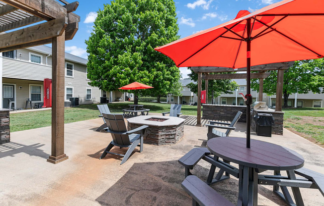 a patio with tables and chairs and umbrellas
