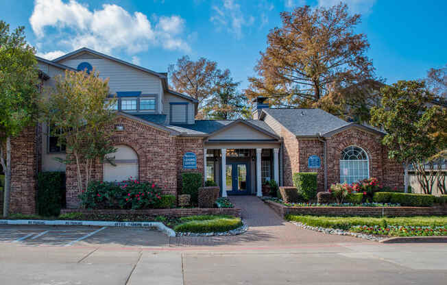 the front of a house with a driveway in front of it