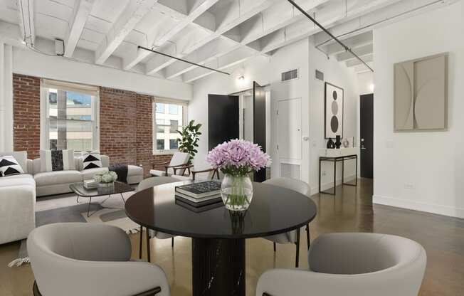 a living room with white furniture and a table with flowers