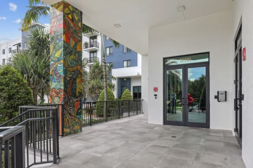 Entrance to our community lobby with pillars with artistic murals at Bay Village 1 in Palmetto Bay, FL