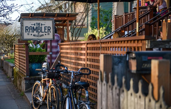 a row of bikes parked in front of a brick fence