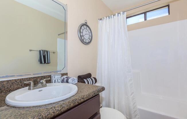 a large white tub next to a sink