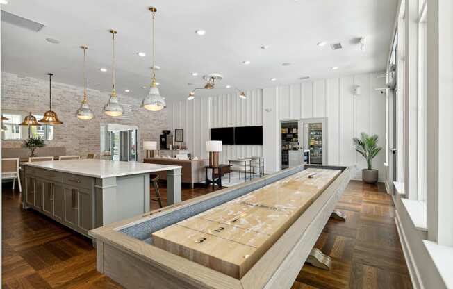 a large kitchen with a bar and a living room