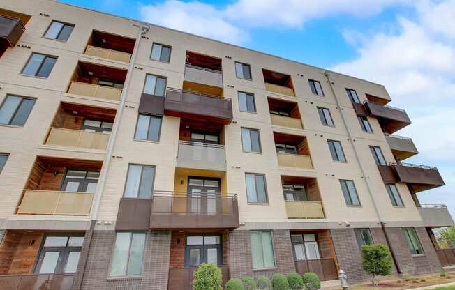 a large apartment building with balconies on the side of it