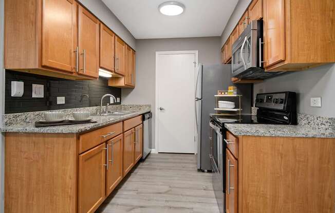 A kitchen with wooden cabinets and a white refrigerator.