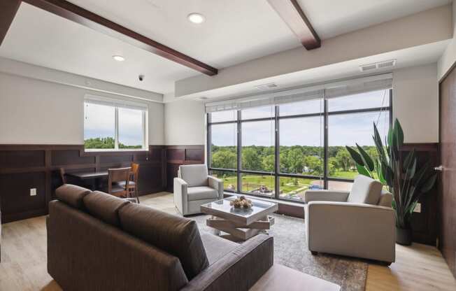 a living room with couches and chairs and a large window