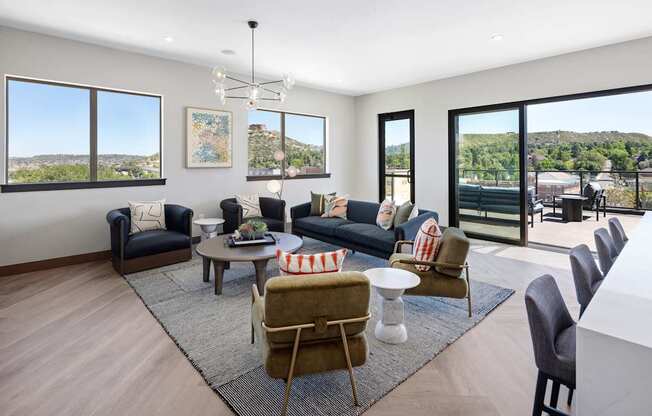 A living room with a large window and a view of the mountains.