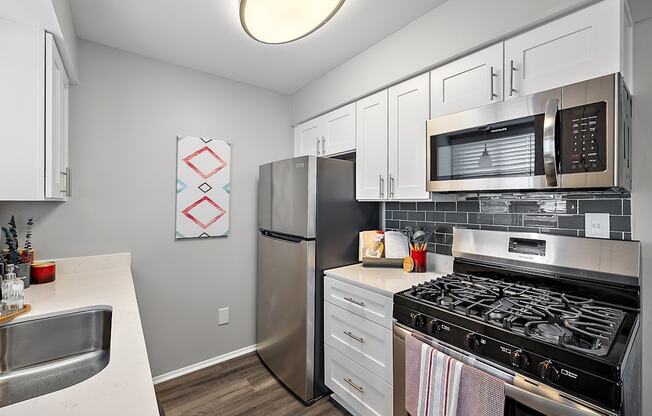 a kitchen with stainless steel appliances and a stainless steel microwave