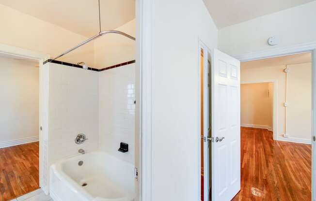 bathroom with tub and views of bedroom and living areas at hampton courts apartments in washington dc