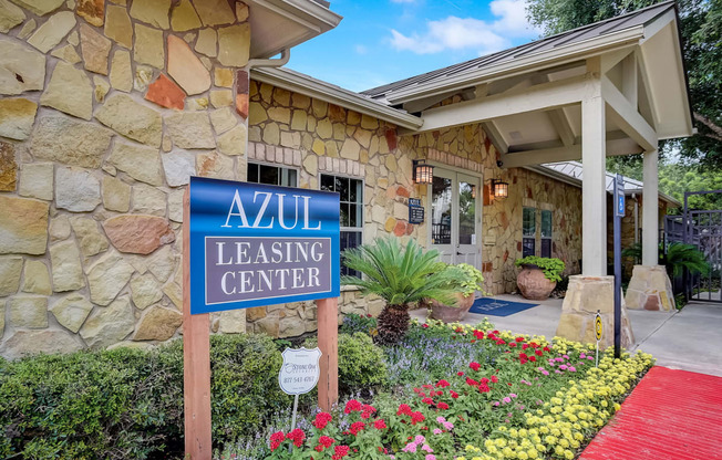 azu leasing center sign in front of a stone building