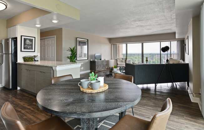 a living room and kitchen with a table and chairs