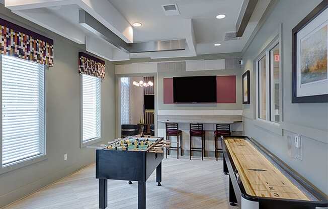 Game room with foosball table, shuffleboard, flat screen TVs