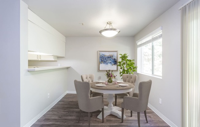 a dining room with a table and chairs