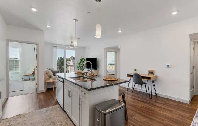 an open kitchen and living room with a large island and a dining room