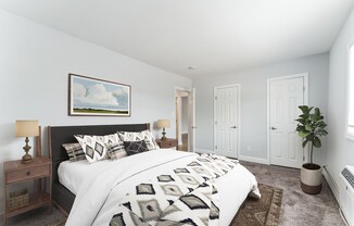 Step into comfort at Mid Island Apartments. This spacious bedroom features modern decor, ample storage, and a serene atmosphere, perfect for relaxation. Elevate your living experience—schedule your visit today!