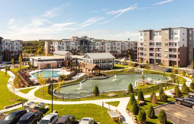 an aerial view of a park with a pool and buildings