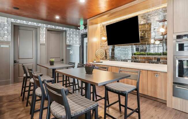 a kitchen with a table and chairs and a television