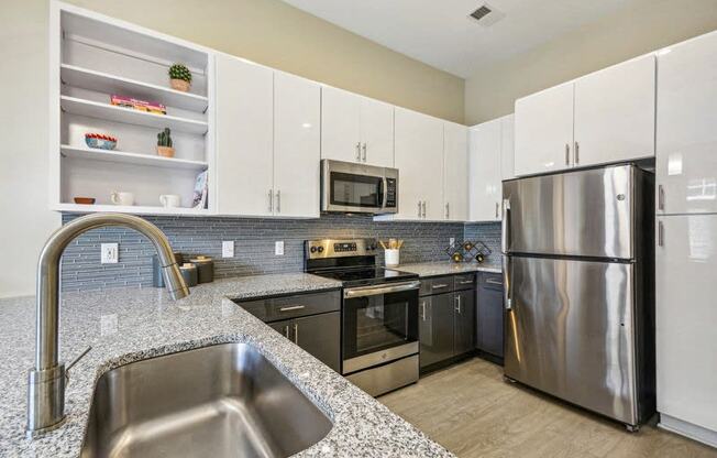a modern kitchen with stainless steel appliances and granite counter tops at Link Apartments Innovation Quarter, Winston Salem, 27101