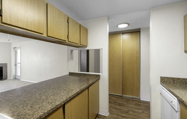 a kitchen with granite countertops and wooden cabinets at Willows Court Apartment Homes, Washington