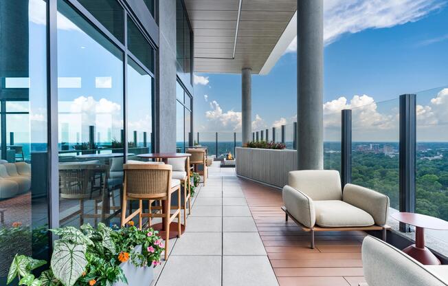 30th-floor terrace with lounge seating, glass railings, and sweeping views across Atlanta, offering a striking backdrop for outdoor relaxation and conversation.