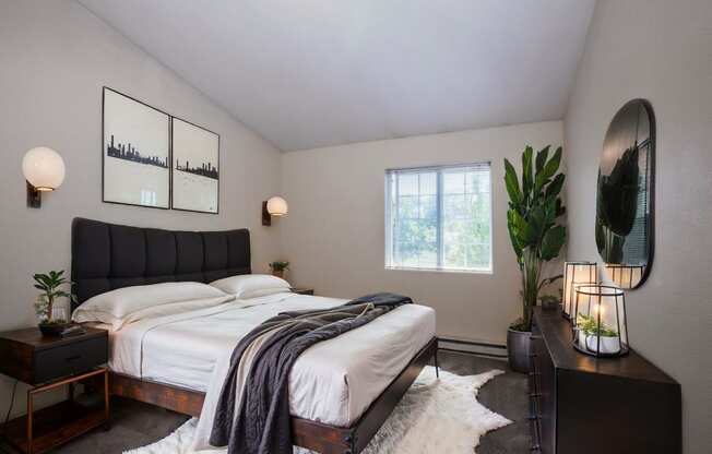 a bedroom with a bed and a potted plant