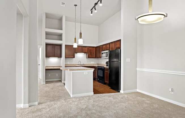 an empty dining room next to a kitchen