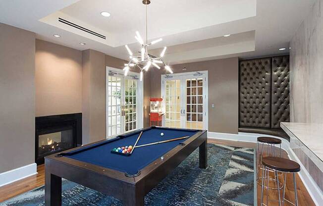 a game room with a pool table and a fireplace