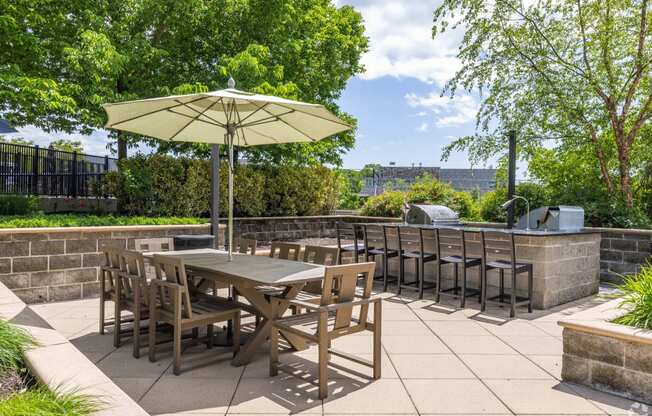 a patio with tables and chairs and an umbrella