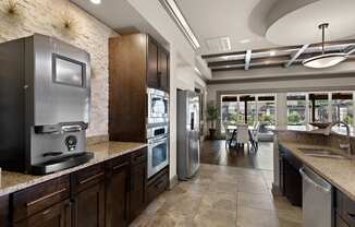 a large kitchen with stainless steel appliances and granite counter tops