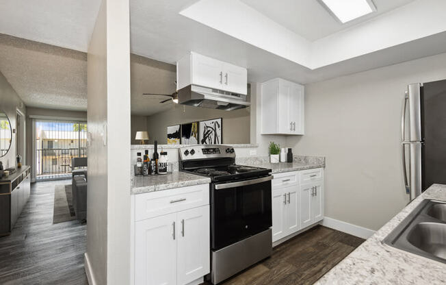 a kitchen with white cabinets and a black stove top oven