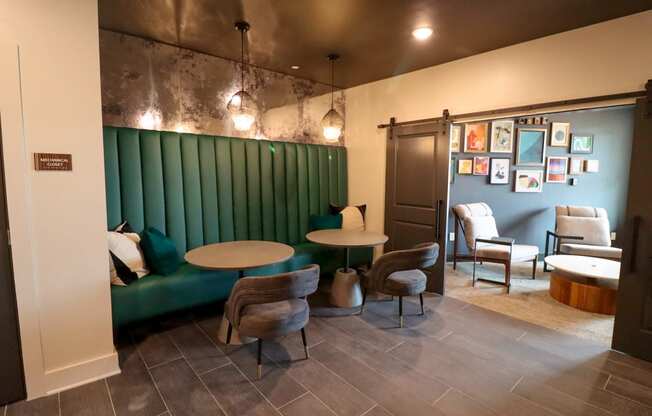 a dining room with a green booth and tables and chairs