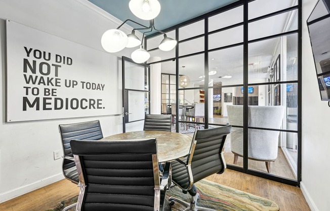 A conference room with a sign on the wall that says