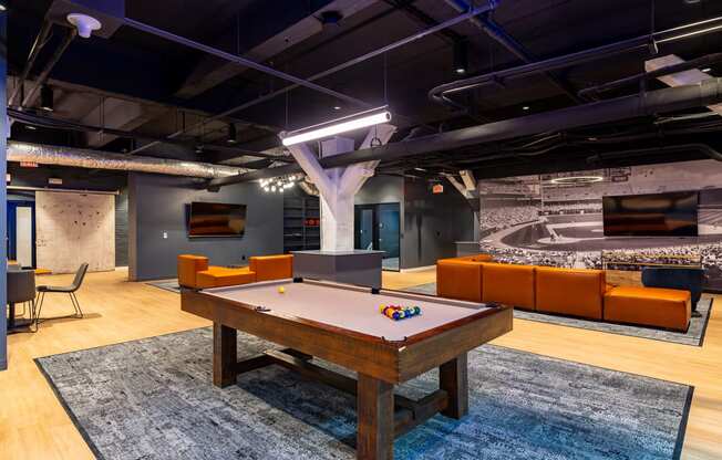 a game room with a pool table and a tv