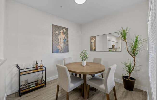 a dining room with a table and chairs