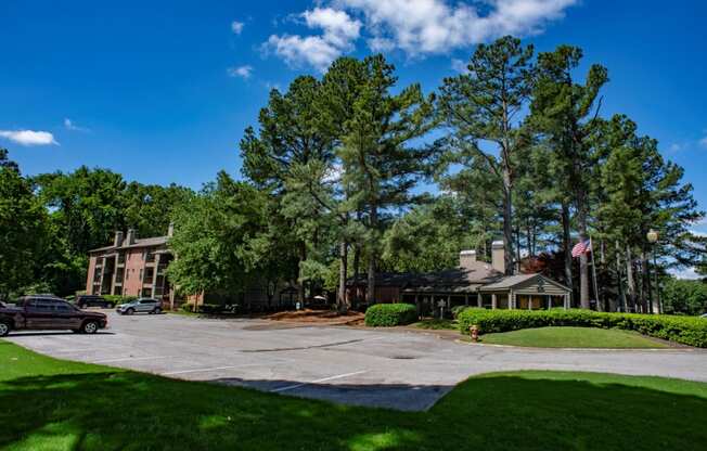 a view of a building with trees and a parking lot at The Summit Apartments, Memphis, TN, 38128