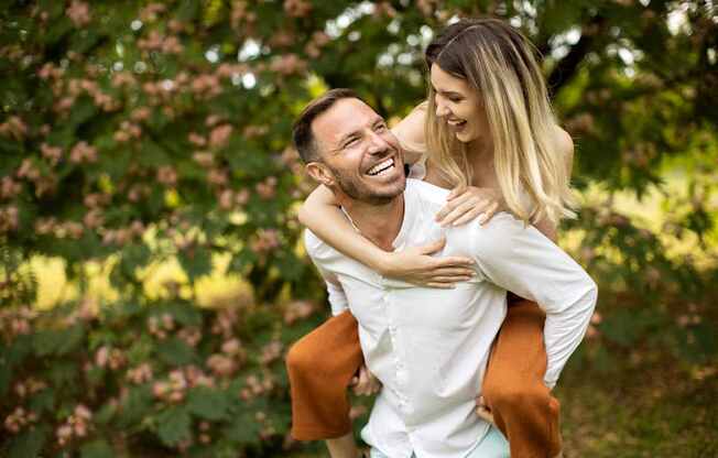 a man carrying a woman on his back at North Grove, Riverside  