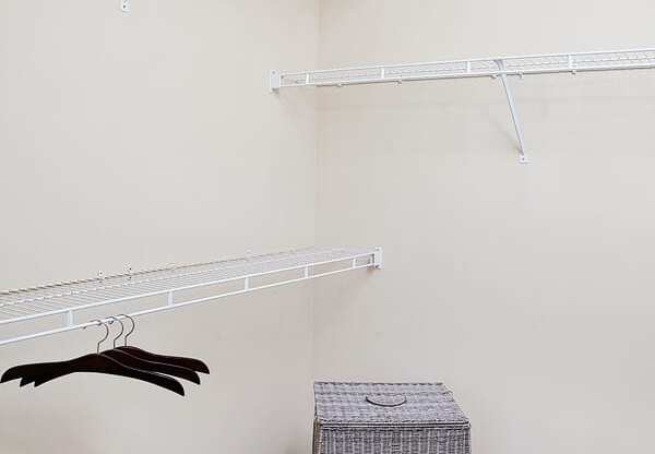 A room with a hanger and a box on the floor.