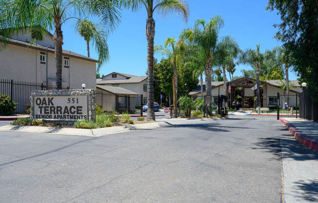 a street with houses on each side and a sign that reads oak 51 terrace at Oak Terrace Senior Apts, Hemet California