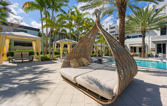 a hanging hammock in a pool area at a resort